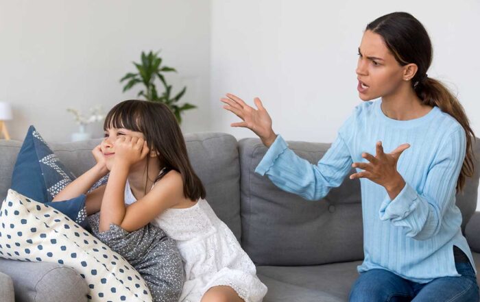 Girl ignoring her mom's instructions and mom showing frustration