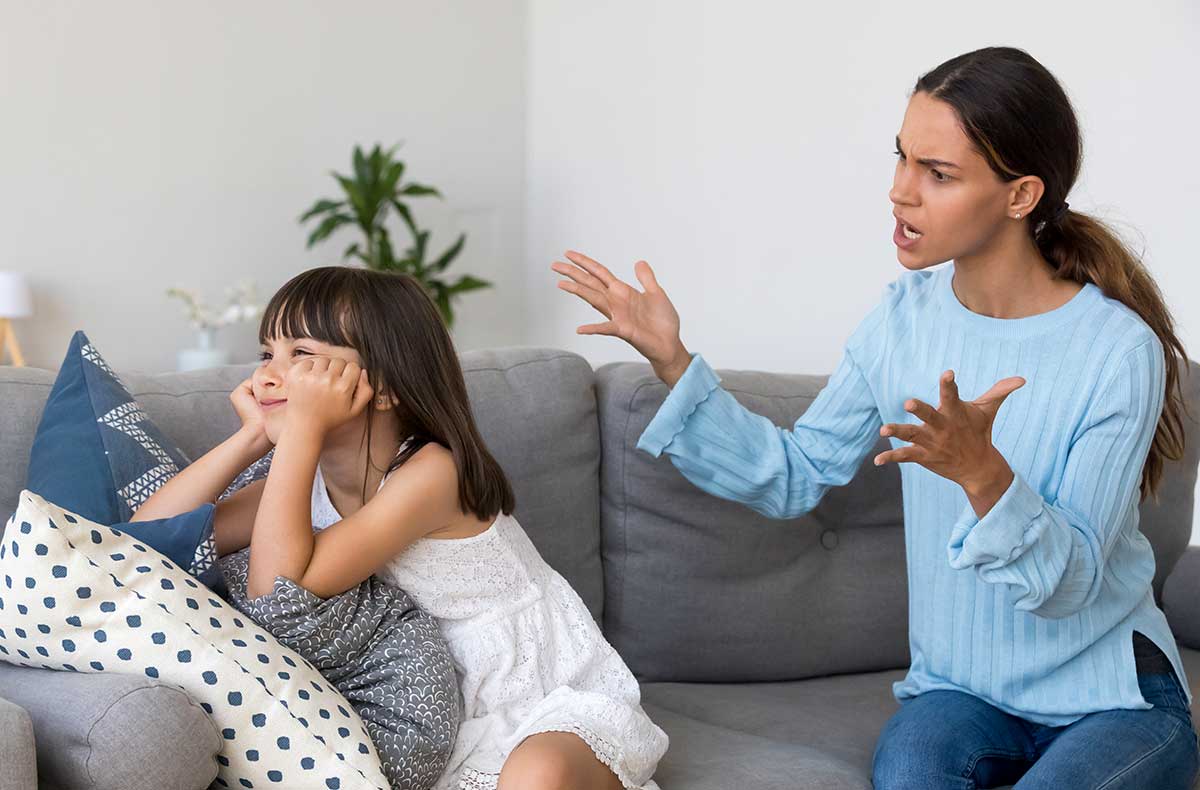 Girl ignoring her mom's instructions and mom showing frustration