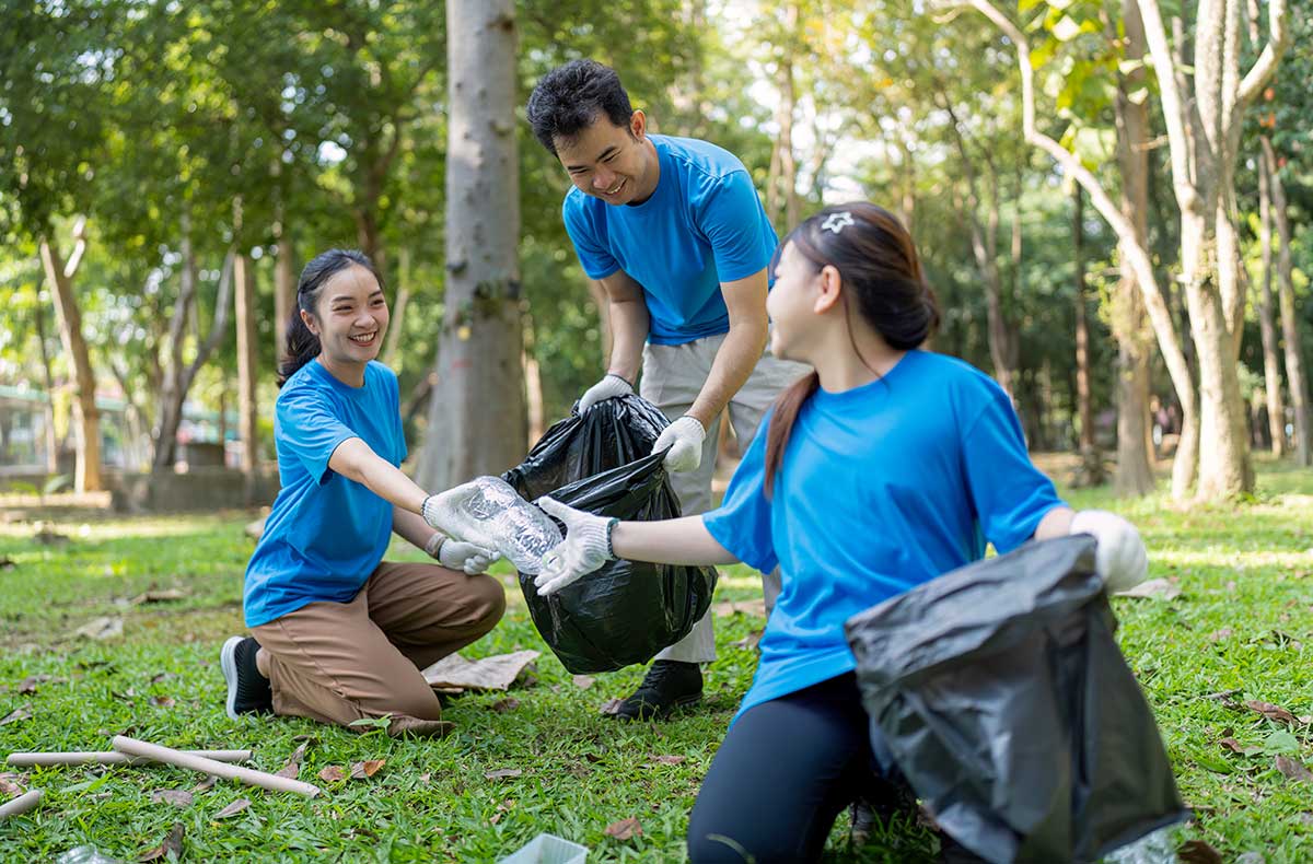 Asian family picking up garbage in a park
